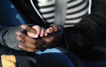 Bi-racial foster siblings hold hands | coyotehill.org