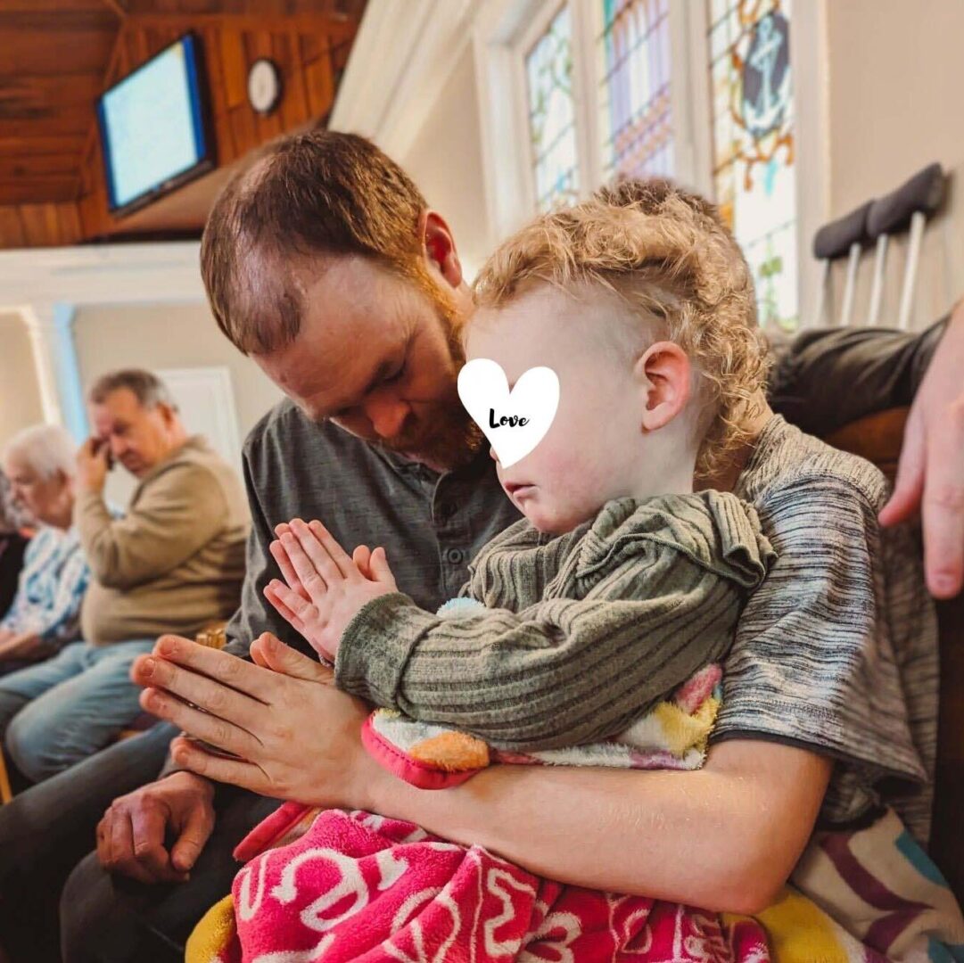 child prays at church with foster dad