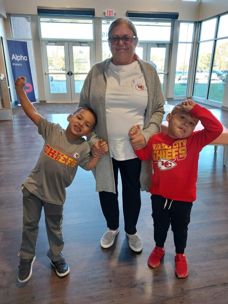 Coyote Hill Adoptive Family pose in Kansas City Chiefs merchandise.
